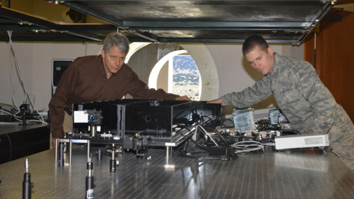 Air Force Research Laboratory researchers Dr. Mark Gruneisen and 2nd Lt. Eddie Hilburn make adjustments to the quantum key distribution testbed at the Starfire Optical range propagation site. (U.S. Air Force photo/Todd Berenger)