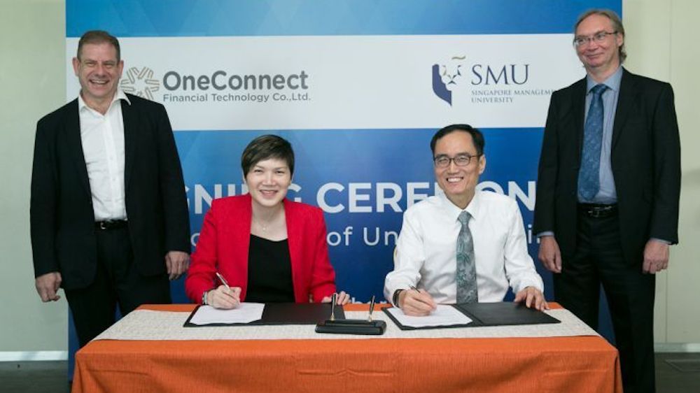 Signing the MOU at SMU today were (seated L-R) Ms Tan Bin Ru, CEO (Southeast Asia) at OneConnect and Professor Pang Hwee Hwa, Dean of SMU School of Information Systems. The signing was witnessed by (standing L-R) Dr Corey Manders, Head of Research and Development at OneConnect Financial Technology and Associate Professor Paul Griffin from SMU School of Information Systems.