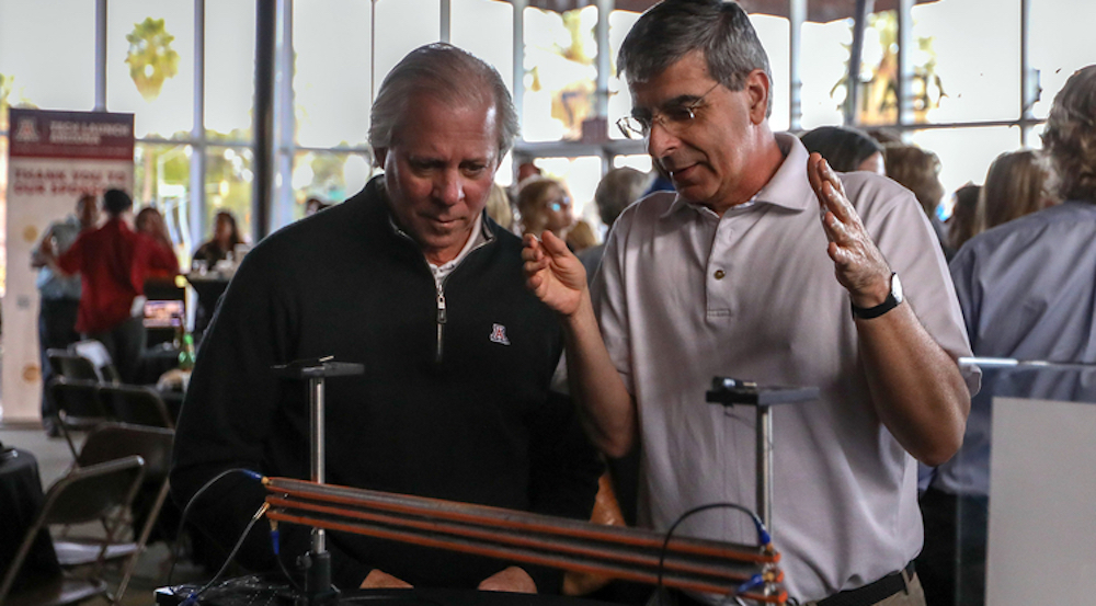 Pierre Deymier (right) and UA President Robert C. Robbins examine the acoustic system that allowed researchers to create Bell states using phonons. (Photo: Paul Tumarkin/Tech Launch Arizona)