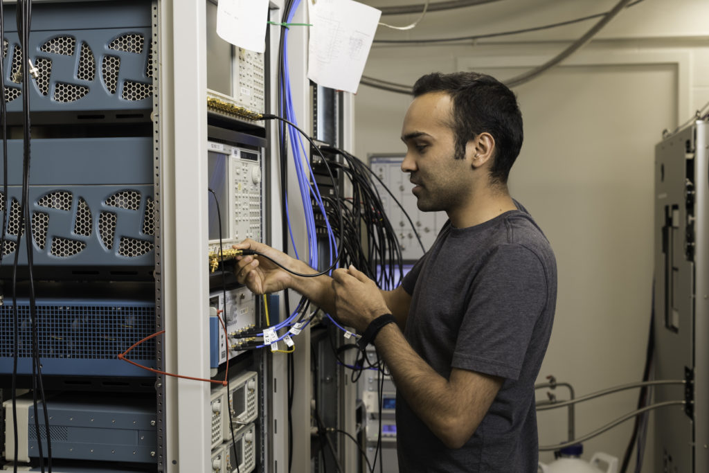 Yadav Kandel, a physics PhD student in assistant professor John Nichol’s lab, uses an arbitrary waveform generator to manipulate qubits. (University of Rochester photo / J. Adam Fenster)