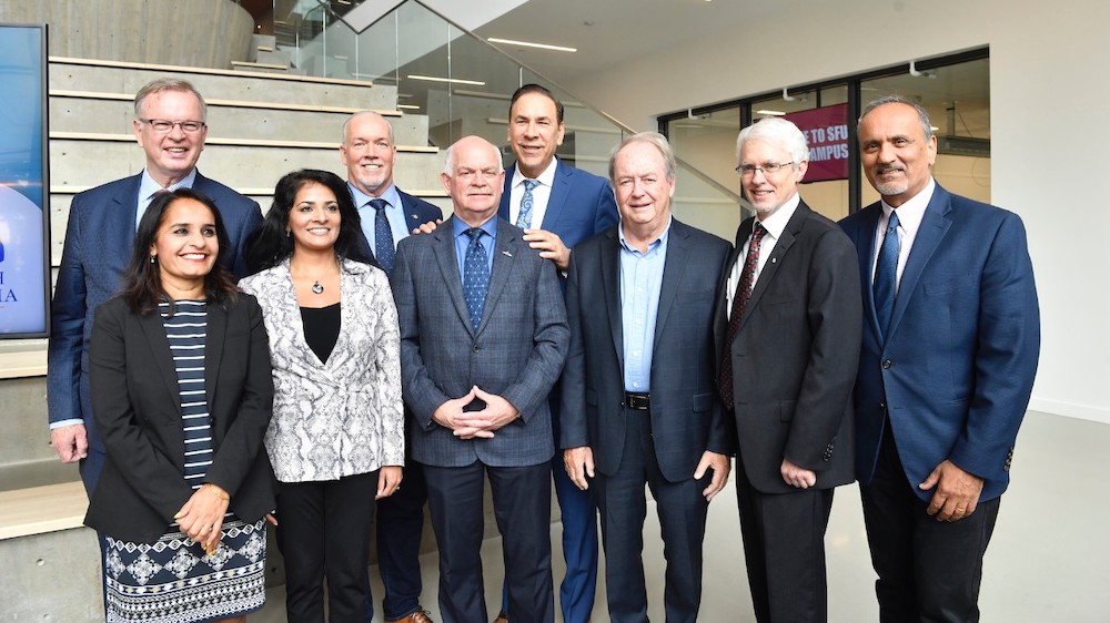 From L-R: Surrey-Green Timbers MLA Rachna Singh, Bruce Ralston, B.C. Minister of Jobs, Trade and Technology, Anita Huberman, CEO, Surrey Board of Trade, Premier John Horgan, Surrey-Guilford MLA Garry Begg, Surrey-Fleetwood MLA Jagrup Brar, Surrey Mayor Doug McCallum, SFU President Andrew Petter and Harry Bains, Minister of Labour. Photo: Greg Ehlers