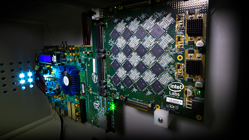 One of Intel’s Nahuku boards, each of which contains 8 to 32 Intel Loihi neuromorphic chips, shown here interfaced to an Intel Arria 10 FPGA development kit. Intel’s latest neuromorphic system, Poihoiki Beach, annuounced in July 2019, is made up of multiple Nahuku boards and contains 64 Loihi chips. Pohoiki Beach was introduced in July 2019. (Credit: Tim Herman/Intel Corporation)